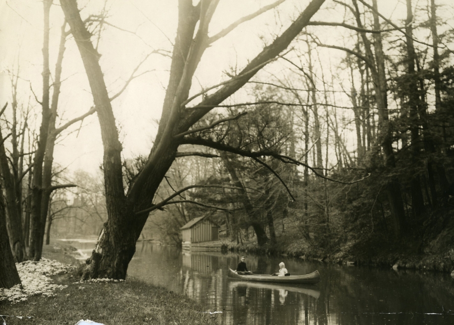 black and white photo of two people canoeing